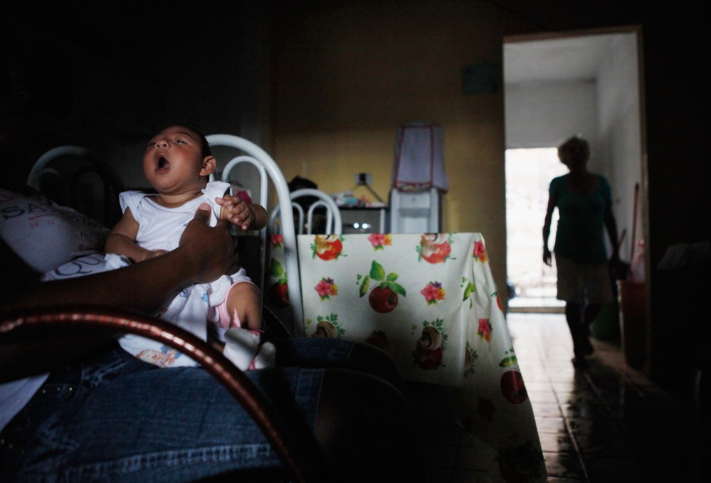 Alice Vitoria Gomes Bezerra, 3-months-old, who has microcephaly, is held by her mother Nadja Cristina Gomes Bezerra on Jan. 31, 2016 in Recife, Brazil. (Photo by Mario Tama/Getty)
