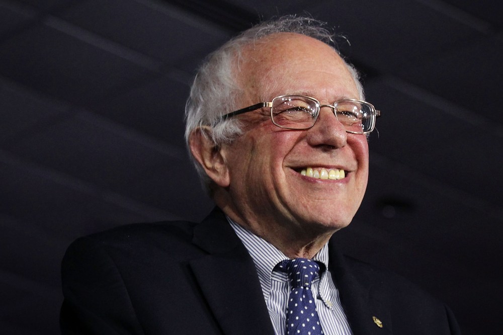 Democratic presidential candidate Sen. Bernie Sanders (I-VT) smiles as he speaks to supporters during a caucus night party Feb. 1, 2016 in Des Moines, Iowa. (Photo by Alex Wong/Getty)