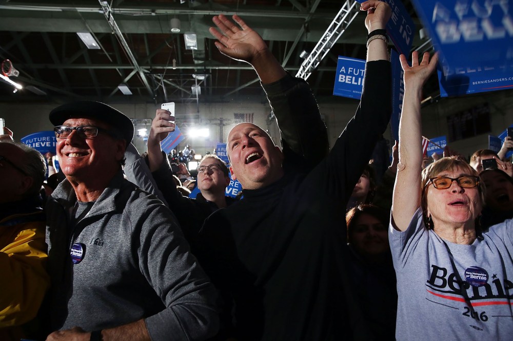People cheer as Sen. Bernie Sanders (D-VT) speaks onstage after victory over Hillary Clinton in the New Hampshire primary on Feb. 9, 2016 in Concord, N.H. (Photo by Spencer Platt/Getty)