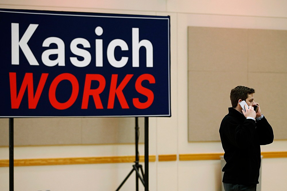 A campaign official for Republican presidential candidate and Ohio Governor John Kasich talks on two phones at a time before a town hall meeting at Utah Valley University on March 18, 2016 in Orem, Utah. (Photo by George Frey/Getty)