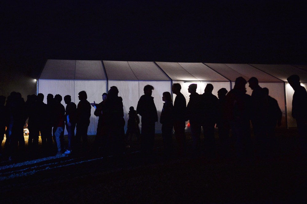 Migrants and refugees line up for soup in the makeshift camp at the Greek-Macedonian border near the village of Idomeni on March 20, 2016. (Photo by Louisa Gouliamaki/AFP/Getty)