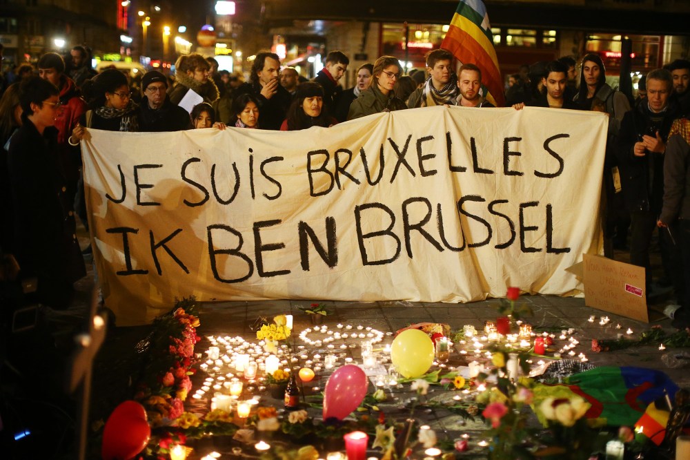 People hold up a banner as a mark of solidarity at the Place de la Bourse following today's attacks on March 22, 2016 in Brussels, Belgium. (Photo by Carl Court/Getty)