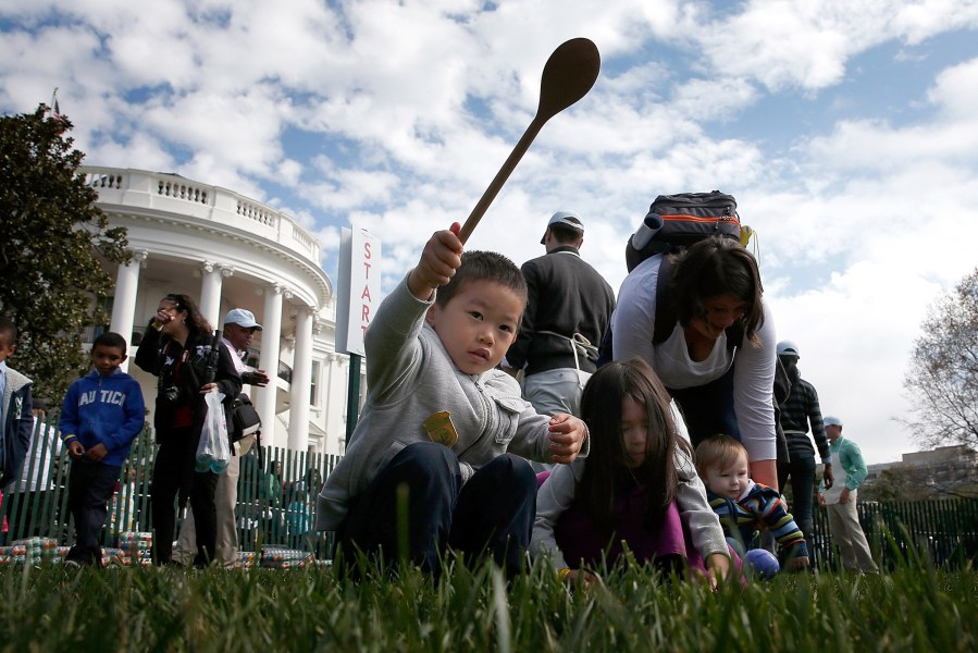 Young children roll Easter eggs on the South Lawn of the White House during the annual White House Easter Egg Roll March 28, 2016 in Washington, D.C. (Photo by Win McNamee/Getty)