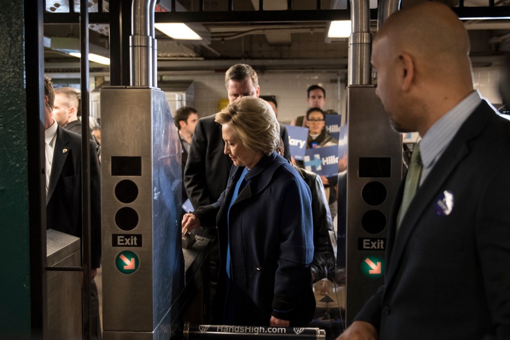 Democratic presidential candidate Hillary Clinton swipes a MetroCard to ride the No. 4 train as she campaigns on April 7, 2016 in the Bronx borough of New York City. (Photo by Andrew Renneisen/Getty)