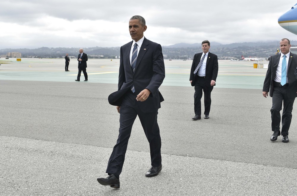 President Obama walks across the tarmac to greet well-wishers upon arrival at San Francisco International Airport, April 8, 2016. (Photo by Mandel Ngan/AFP/Getty)