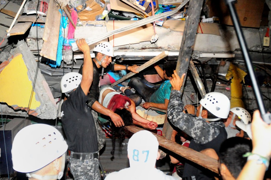 Rescue workers work to pull out survivors trapped in a collapsed building after a huge earthquake struck, in the city of Manta early on April 17, 2016. (Photo by Ariel Ochoa/AFP/Getty)