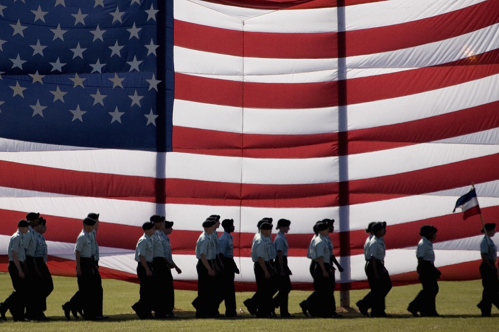 Troops march past a large American flag as they graduate from Basic Combat Training at Fort Jackson, S.C., Nov. 2, 2007. (Photo by Paul J. Richards/AFP/Getty)