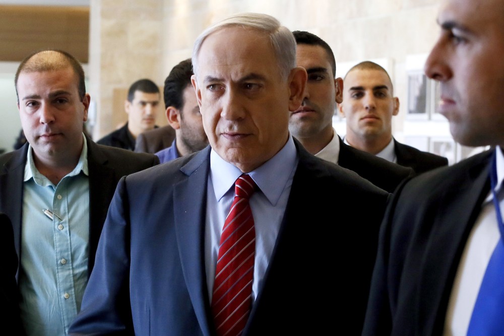 Surrounded by bodyguards, Israeli Prime Minister Benjamin Netanyahu arrives to the Likud faction meeting at the Knesset (Israel's Parliament) on Dec. 3, 2014 in Jerusalem. (Photo by Gali Tibbon/AFP/Getty)