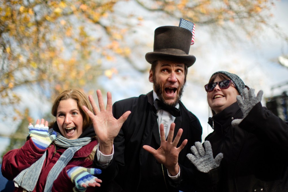 Rick Miller a President Abraham Lincoln re-enactor poses for photographs after a ceremony commemorating the 150th anniversary of the dedication of the Soldiers National Cemetery and President Abraham Lincoln's Gettysburg Address, Tuesday, Nov. 19, 2013,