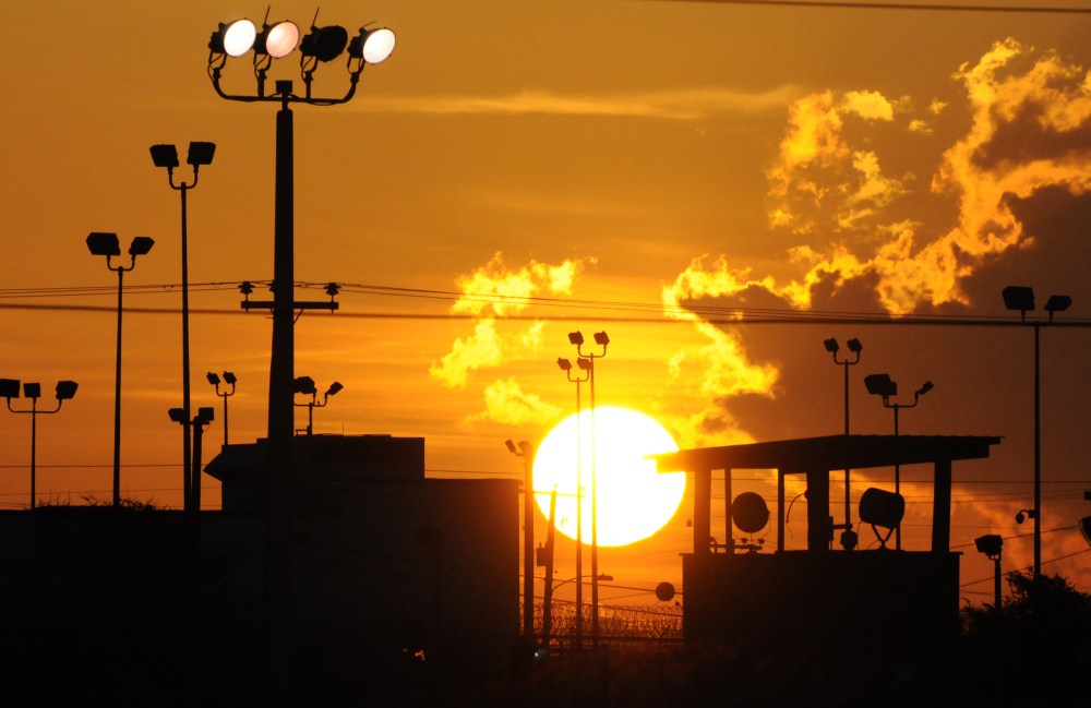 In this photo reviewed by the U.S. Department of Defense, towers overlooking a U.S. detention facility are silhouetted against a morning sunrise at Guantanamo Bay U.S. Naval Base, Cuba, Thursday, Oct. 18, 2012.  (AP Photo/Toronto Star, Michelle...