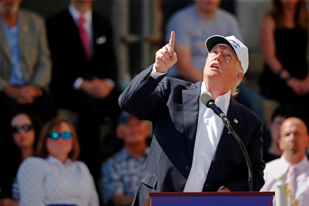 Republican presidential candidate Donald Trump points to an airplane passing overhead at a town hall-style campaign event at the former Osram Sylvania light bulb factory, June 30, 2016, in Manchester, N.H. (Photo by Robert F. Bukaty/AP)
