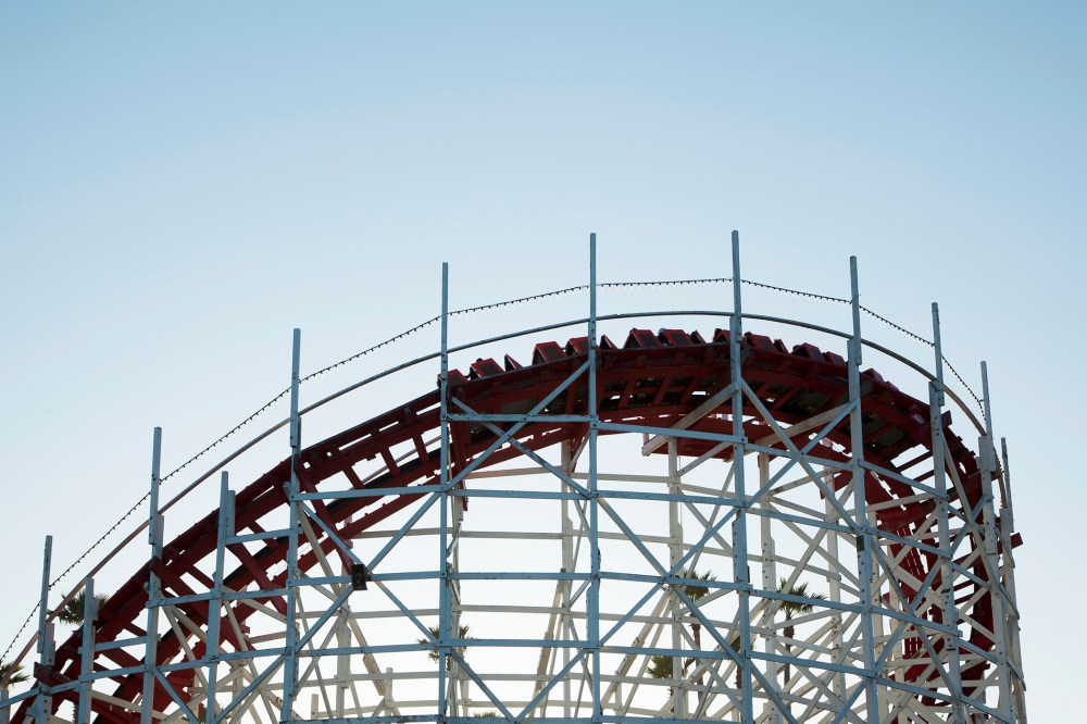 Roller coaster cars turn on a curve. (Photo by Stephen Tamiesie/Gallery Stock)
