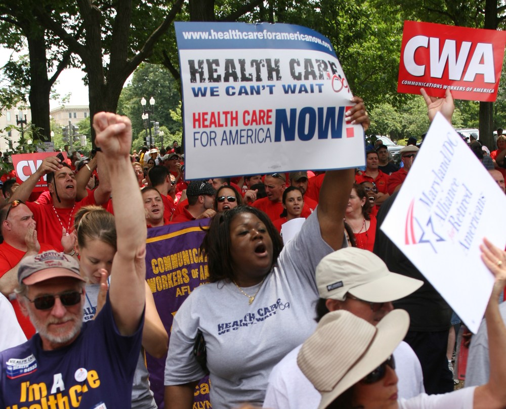 People march during a rally for affordable health care June 25, 2009 on Capitol Hill in Washington, D.C.