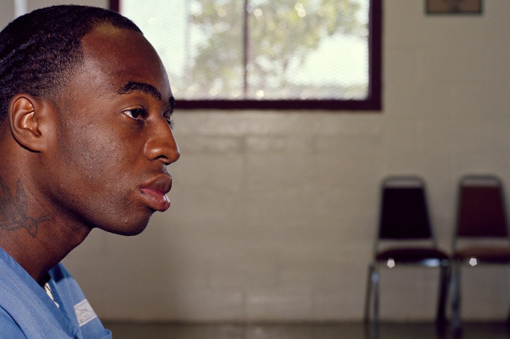 Kenneth Young, a prisoner at Lake Correctional Institution in Florida, sits in the visitors room. He received four life sentences for armed robberies as a minor in 2000.