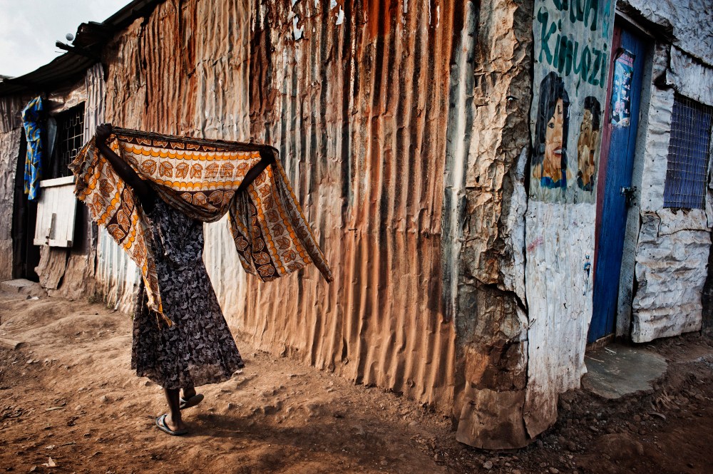 A woman covers her head with a shawl.