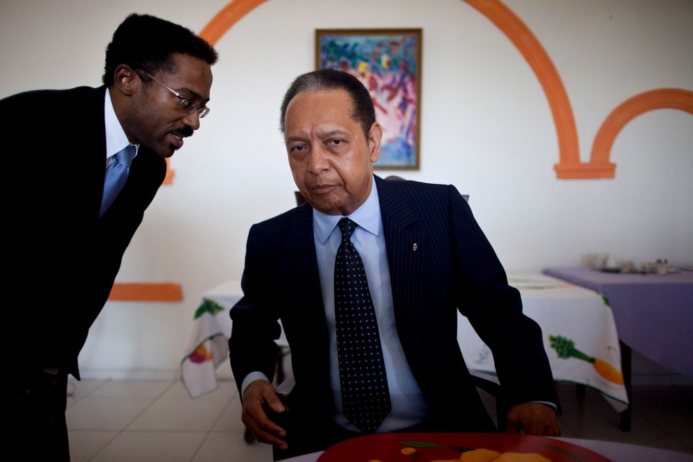 Jean-Claude Duvalier, right, Haiti's former dictator known as Baby Doc, listens to a translator during a meeting, in Port-au-Prince, Haiti, Jan. 24, 2011.