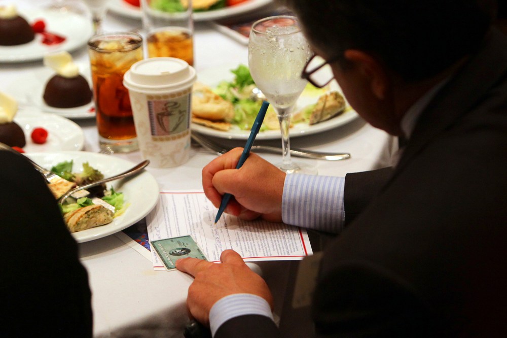 An attendee makes an additional donation during a fundraiser in Atlanta on Sept. 19, 2012.