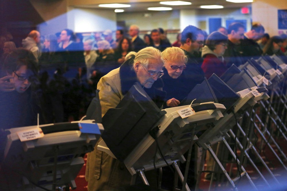 Voters cast ballots inside a polling station at Cross Community Church.