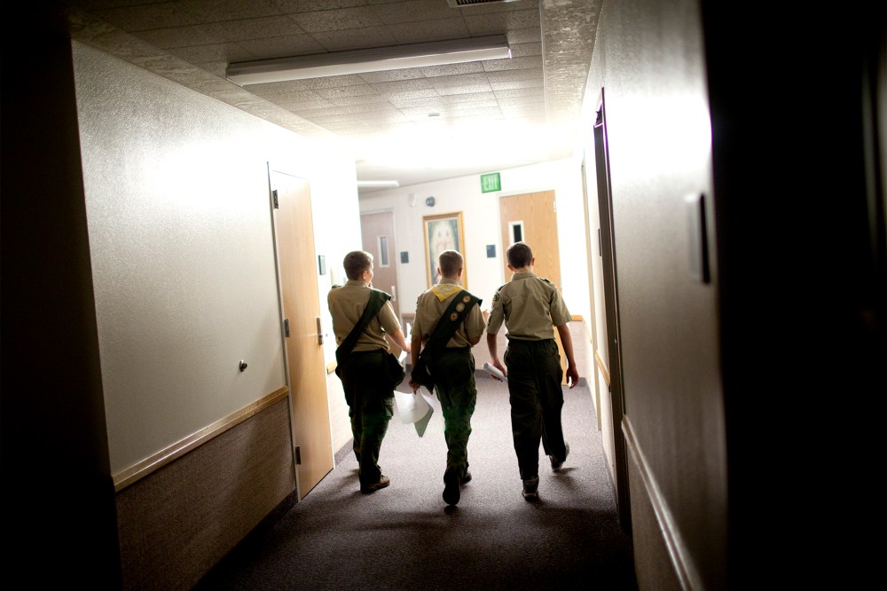 Boy scouts walk through the empty halls of a meeting house of the Church of Jesus Christ of Latter-day Saints, in Cedar Hills, Utah, Oct. 11, 2012.