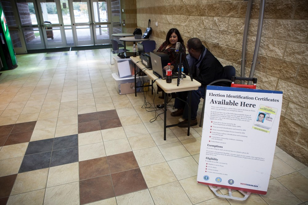 Department of Public Safety employees attend to a voter identification station in Houston. (Michael Stravato/The New York Times)