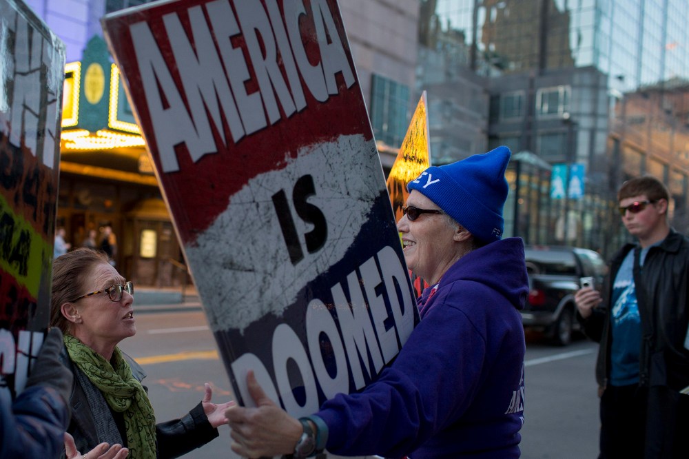 Barbara Moore, left, questions Westboro Church Member Shirley Phelps-Roper during a protest outside a Young the Giant concert at The Midland, Kansas City, Mo., March 19, 2014.
