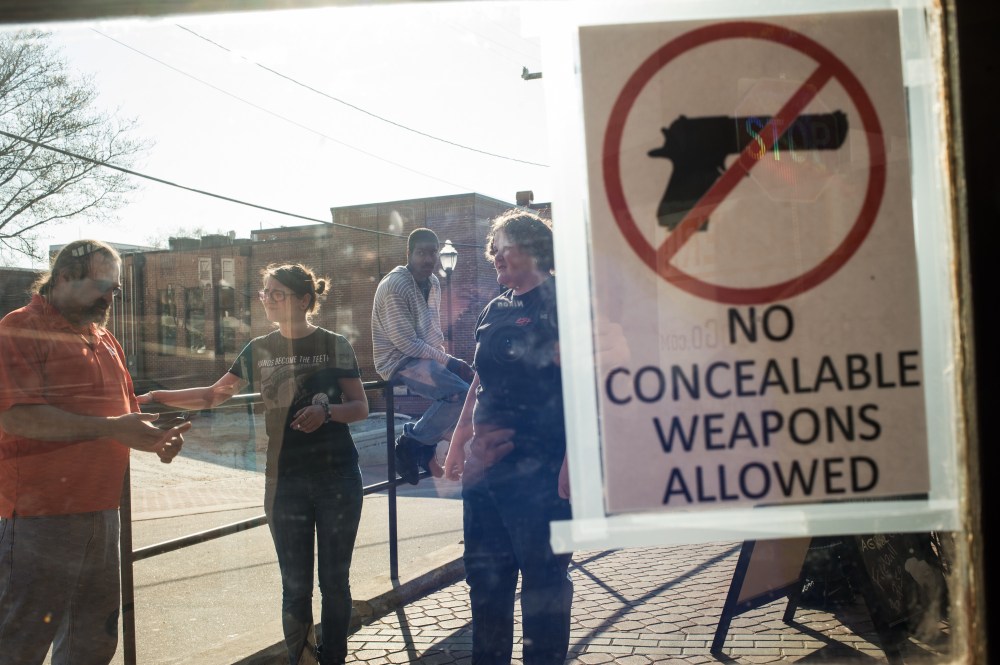Pete Matsko, left, gathers with his staff outside the Backstreets Pub and Grill in Clemson, S.C.