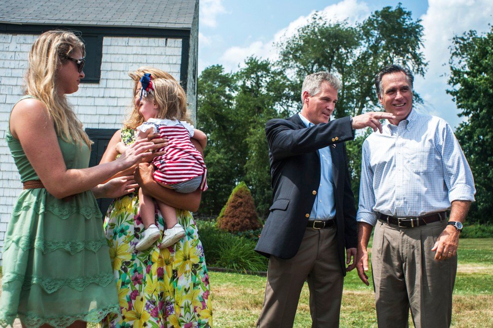 Mitt Romney speaks with Scott Brown in Stratham, N.H., July 2, 2014.