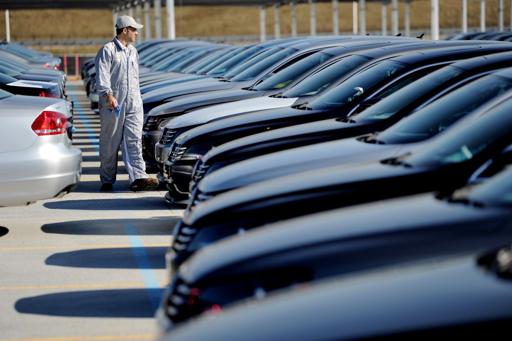 An employee looks over cars at the Volkswagen automobile assembly plant in Chattanooga, Tenn., on Feb. 21, 2012. (Photo by Erik S. Lesser/EPA)
