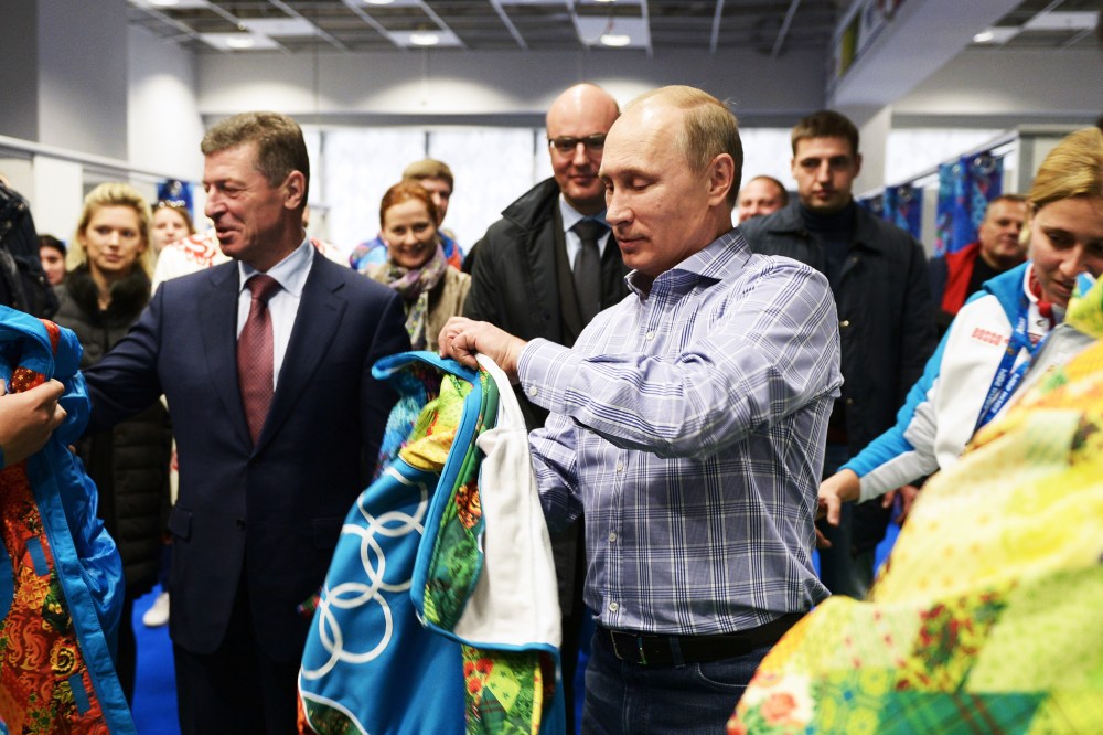 Russian President Vladimir Putin tries on a Sochi jacket, Jan. 4, 2014.