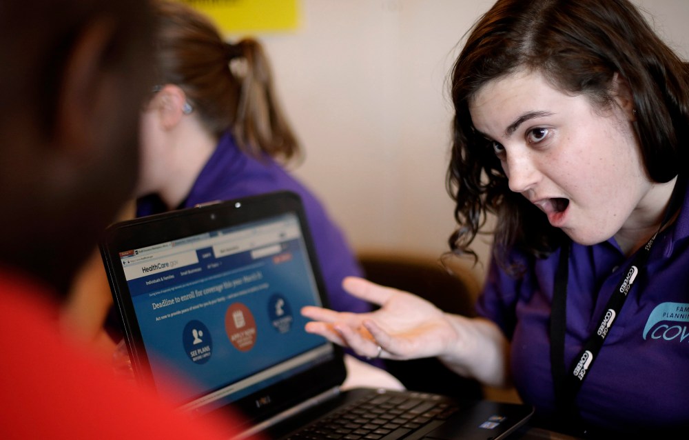 Elizabeth Rich helps a man sign up for the Affordable Care Act at Swope Health Services in Kansas City, Mo., March 31, 2014.