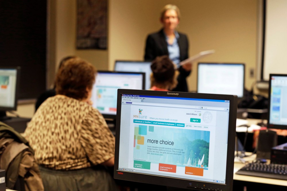 In this photo made Wednesday, November 13, 2013, Maureen O'Connell addresses people in attendance at the "MNsure Crash Course" at the St. Paul Library to help them understand how federal health care reform affects their lives.