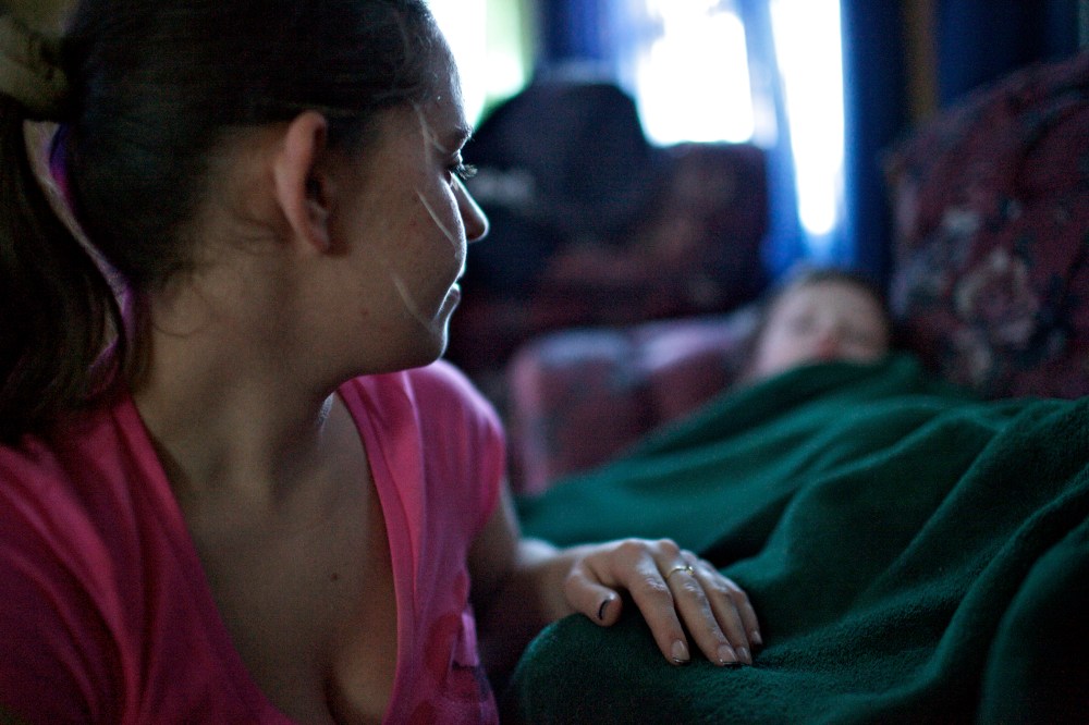 Alicia, a mother in Johnstown, Pa., tucks her two sons after returning home from working the night shift at a senior citizen home. Alicia has two young boys and her boyfriend does not work, making her the sole provider for her family.