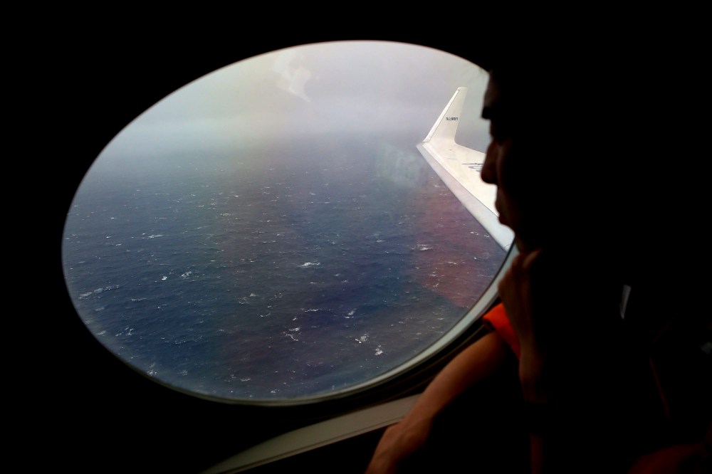 Koji Kubota of the Japan Coast Guard keeps watch for debris on board the Japan Coast Guard Gulfstream V aircraft whilst in the search zone for debris from Malaysia Airlines flight MH370 on April 1, 2014.