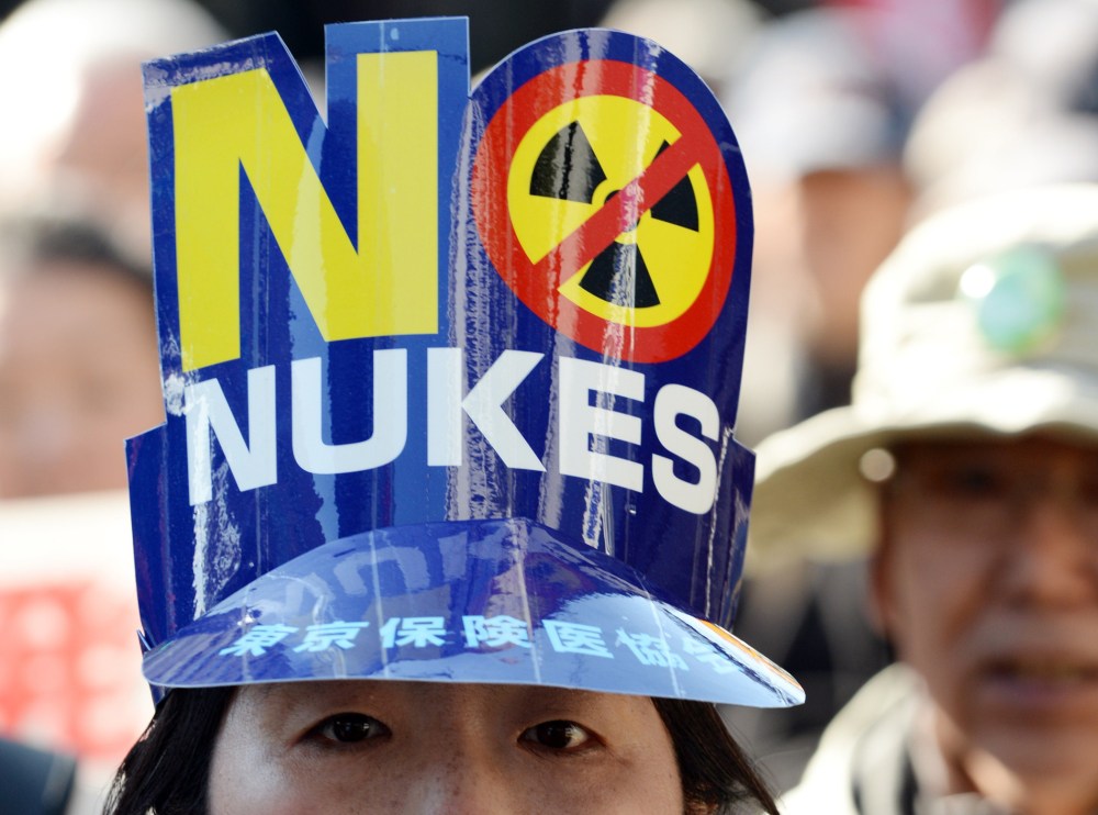 A protester wears a "No Nukes" hat during an anti-nuclear demonstration march in Tokyo on March 15, 2014.