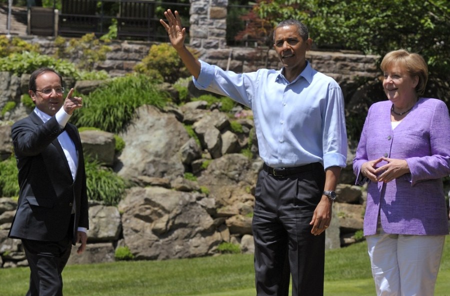 French President Francois Hollande, left, U.S. President Barack Obama and German Chancellor Angela Merkel, arrive at the family photo session at the G-8 Summit at Camp David, Md., Saturday, May 19, 2012.