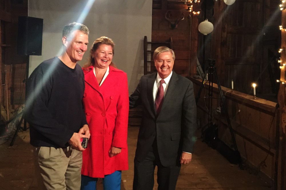 Sen. Scott Brown and his wife, journalist Gail Huff, pose with Sen. Lindsey Graham after the presidential candidate spoke at one of Brown's “No BS Backyard BBQs.” (Photo by Kailani Koenig)