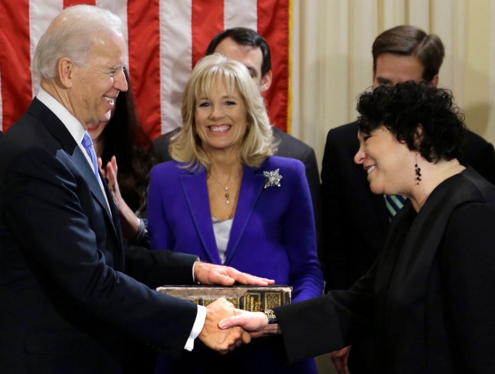 Vice President Joe Biden, with his wife Jill Biden, center, holding the Biden Family Bible, shakes hands with Supreme Court Justice Sonia Sotomayor after taking the oath of office during an official ceremony at the Naval Observatory, Sunday, Jan. 20,...