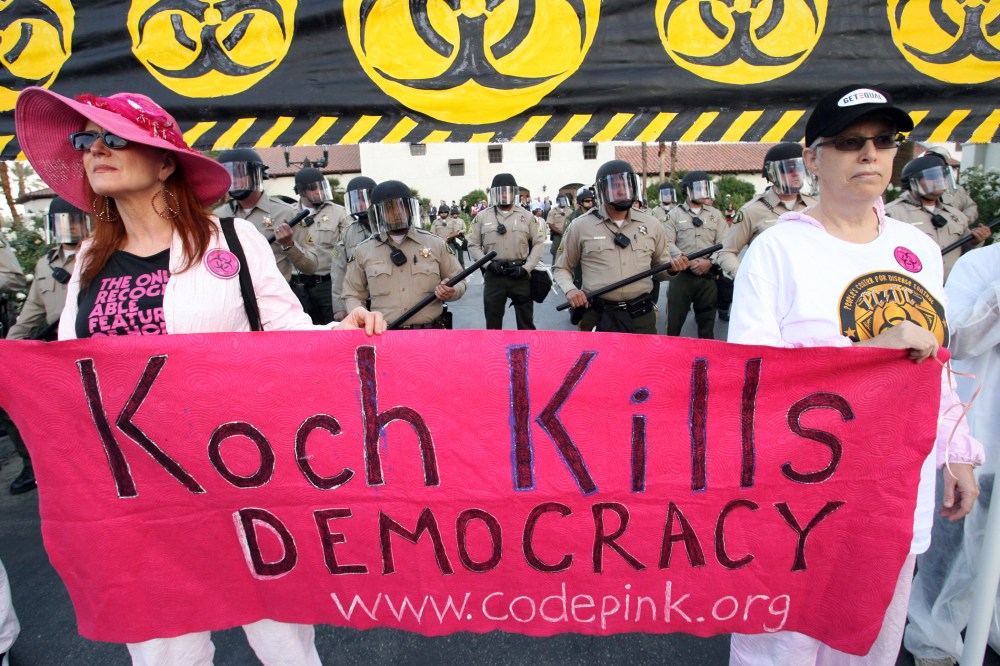 Riverside County Sheriff's deputies in riot gear are seen during a protest dubbed the "Koch Busters Rally" on Sunday, Jan. 30, 2011, in Rancho Mirage, Calif.