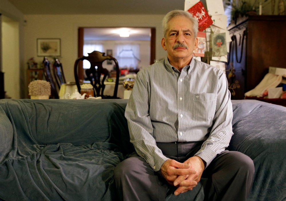 In this Jan. 10, 2014 photo, Stan Osnowitz poses in his living room in Baltimore. Osnowitz, 67, lost his state unemployment benefits of $430 a week in December.