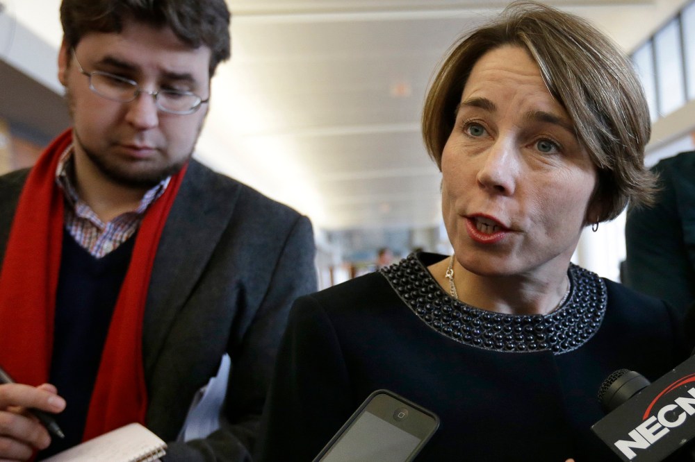 Massachusetts Attorney General Maura Healey, center, speaks with members of the media on Jan. 22, 2015, in Boston.