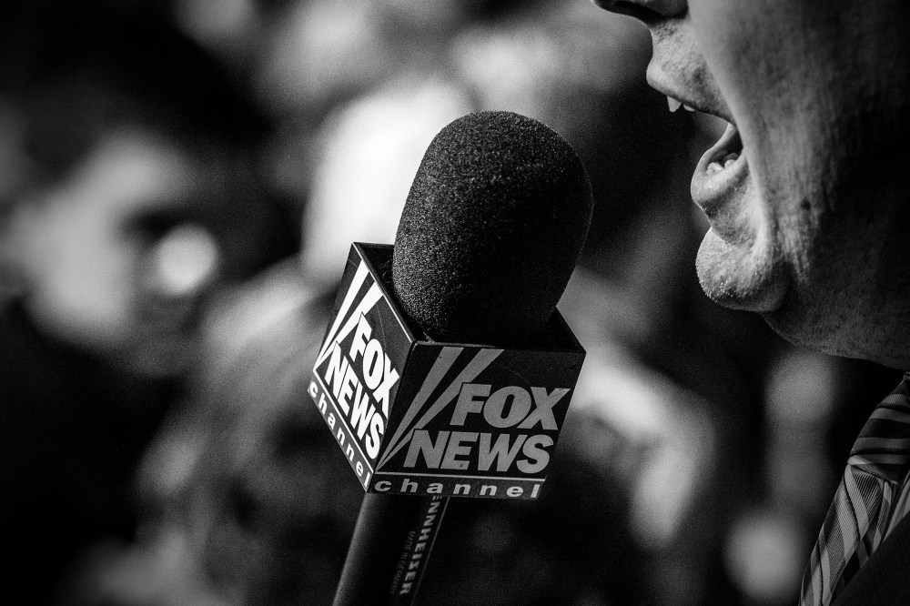 A Fox News reporter works from the Bernie Sanders rally in Iowa City, Ia., Jan. 30, 2016. (Photo by Mark Peterson/Redux for MSNBC)
