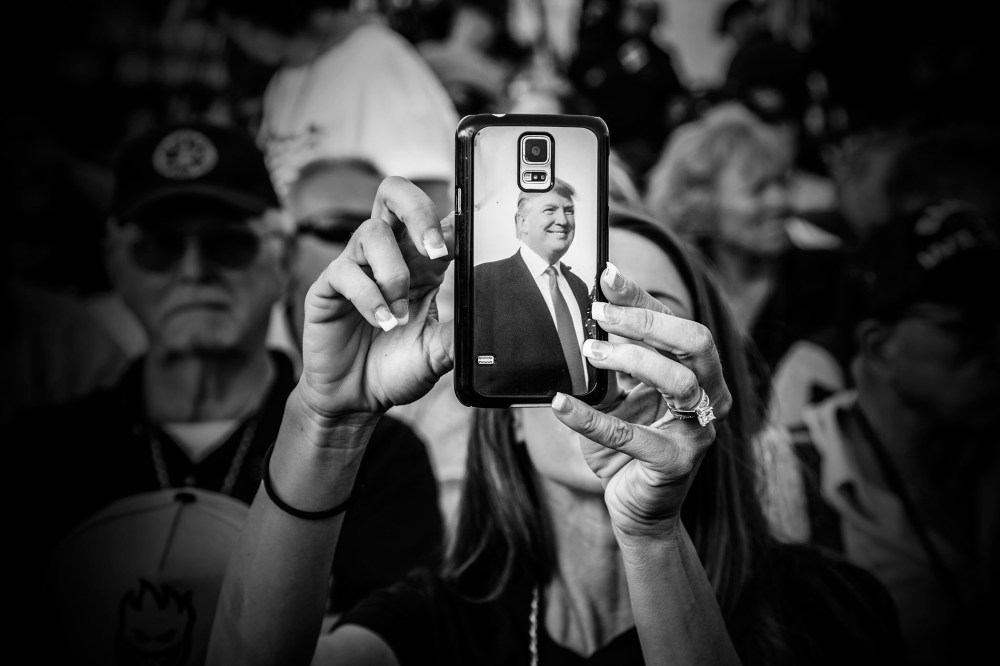 A Donald Trump supporter uses her phone as the billionaire arrived at his "Make America's Military Great Again" rally, held aboard the retired USS Iowa battleship, in Los Angeles, Calif., Sept. 15, 2015. (Photo by Mark Peterson/Redux for MSNBC)