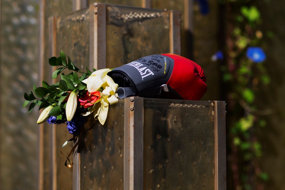 Flowers and a boxing glove are left at a makeshift memorial to Muhammad Ali at the Muhammad Ali Center, June 6, 2016, in Louisville, Ky. (Photo by David Goldman/AP)