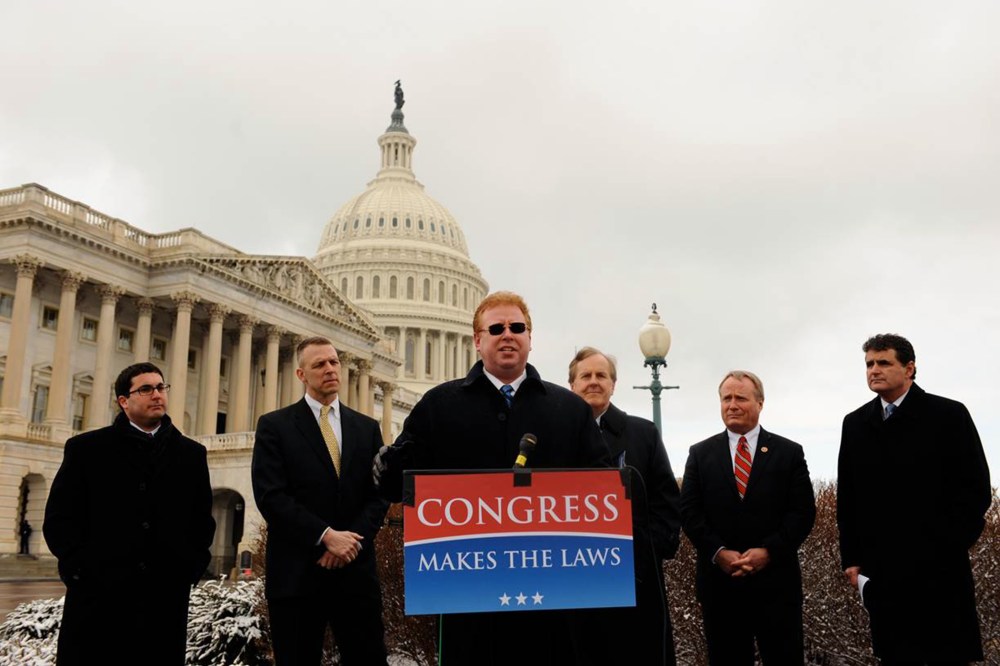 Dr. Larry Kawa, center, speaks about his lawsuit against the IRS regarding the employer mandate in the Affordable Care Act.