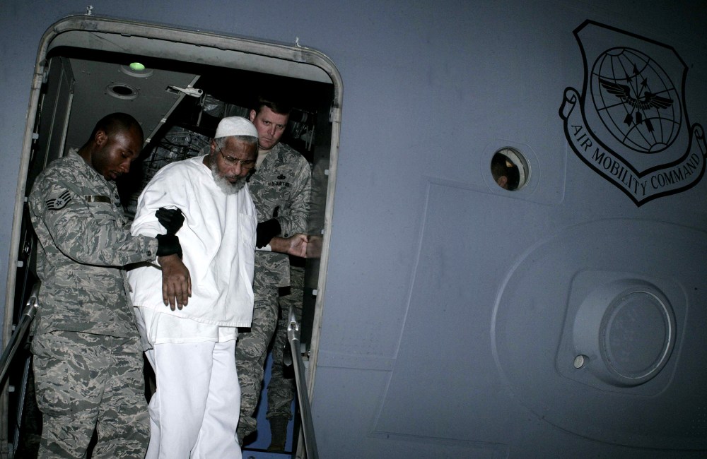 US soldiers help Sudanese Guantanamo prisoner Ibrahim Othman Ibrahim Idris exit a US military plane at Khartoum airport following his release from the Cuba-based US prison on Dec. 19, 2013.