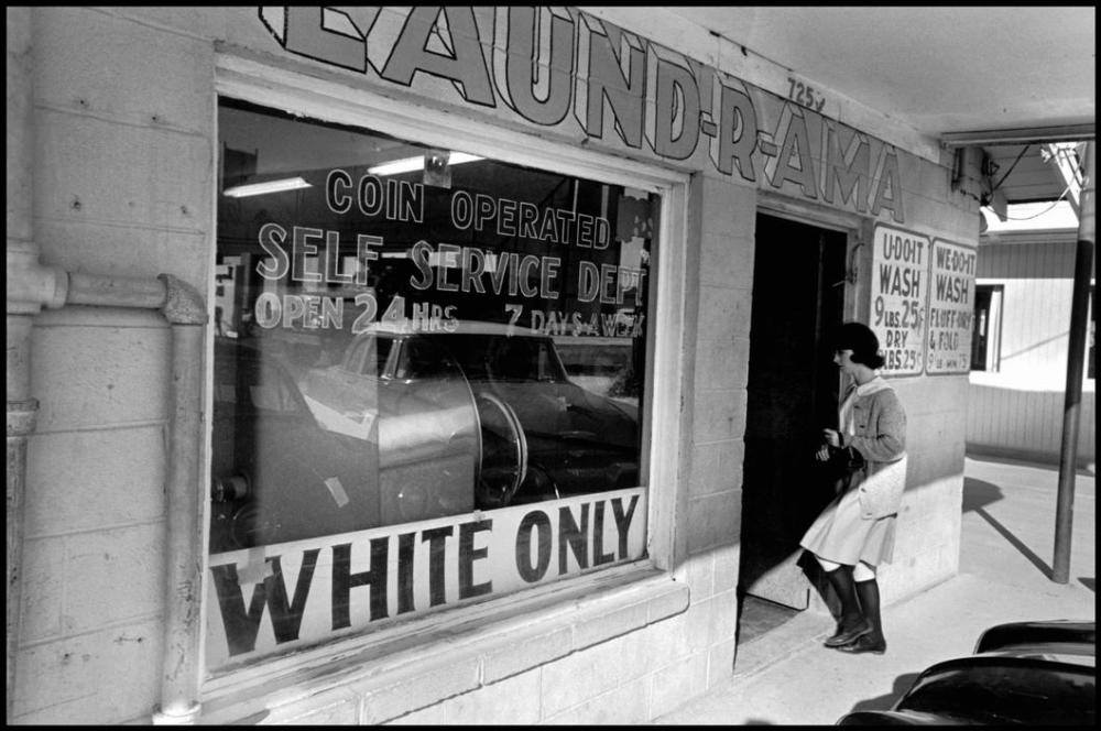 A woman entering a segregated laundromat in Louisiana, New Orleans, 1963.