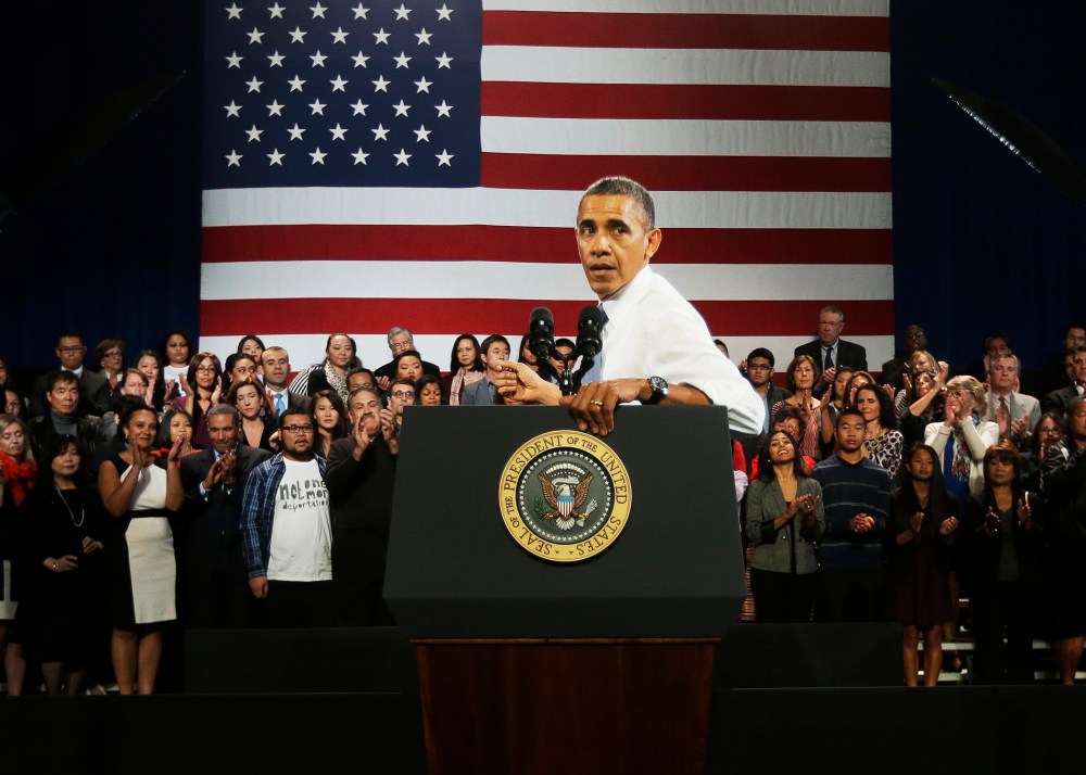 President Barack Obama turns around to respond to hecklers interrupting his speech about immigration reform, Nov. 25, 2013.