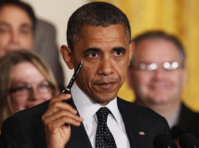 President Barack Obama holds up a pen as he delivers a statement on the "fiscal cliff" in the East Room of the White House in Washington, November 9. The president  he was ready to sign a bill "right away" to extend the Bush tax cuts for the bottom 98%...