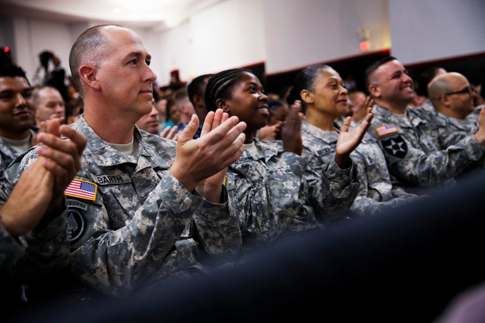 Members of the military applaud as President Barack Obama speaks about the Veteransâ Access to Care through Choice, Accountability, and Transparency Act, Aug. 7, 2014.