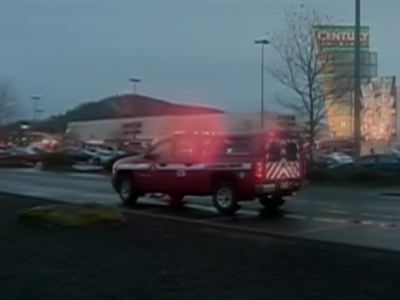 An ambulance rushes toward a mall in Portland, Oregon where a deadly shooting occurred Tuesday evening
